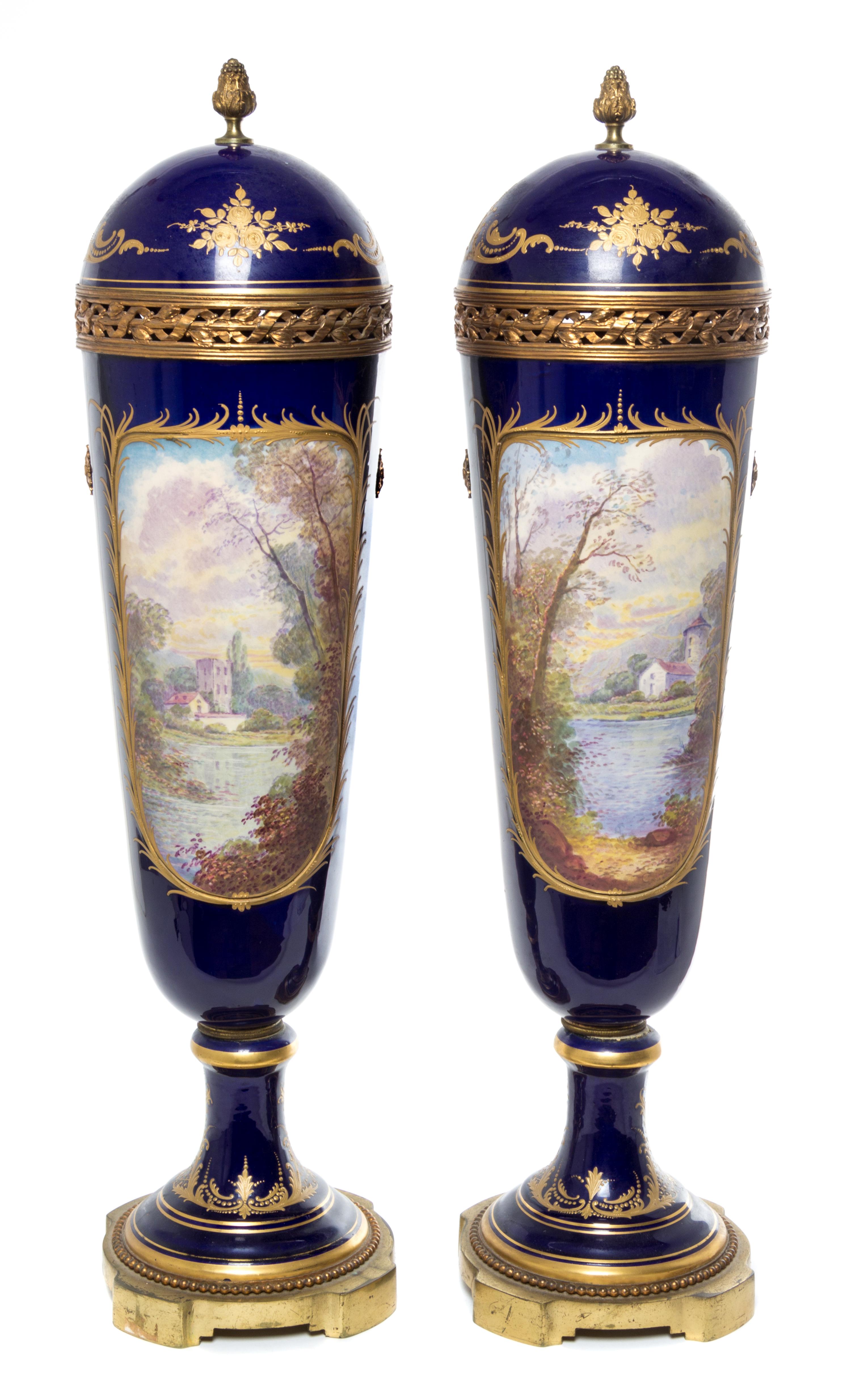 A Pair of Sevres Porcelain Lidded Urns Height 28 inches.