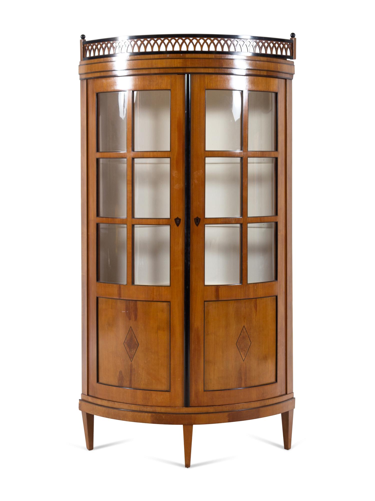 A Biedermeier Parcel Ebonized Fruitwood Corner Cupboard