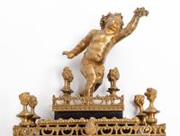 A Napoleon III Style Gilt Bronze and Red Tortoiseshell Bracket Clock with an Associated Bracket