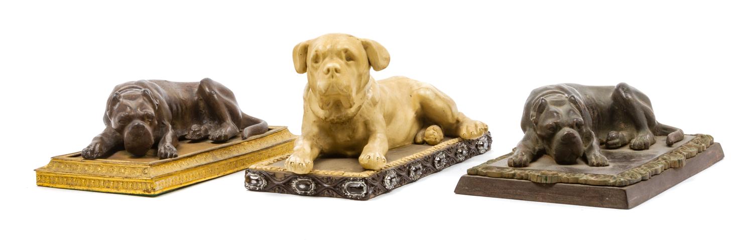 A Group of Three Reclining Mastiff Figures Width 10 inches.