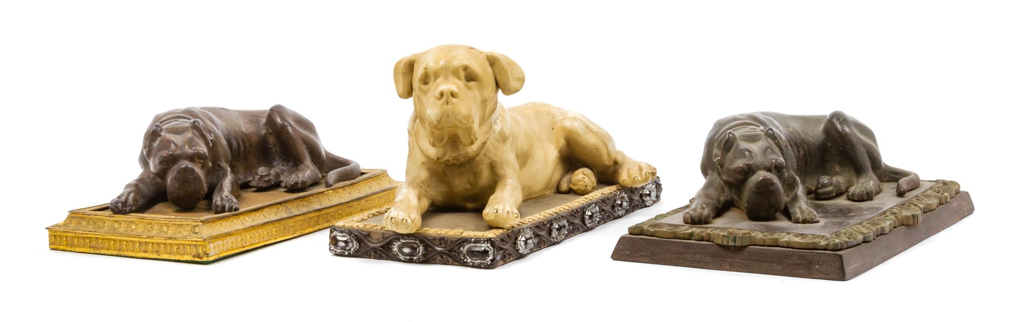 A Group of Three Reclining Mastiff Figures Width 10 inches.