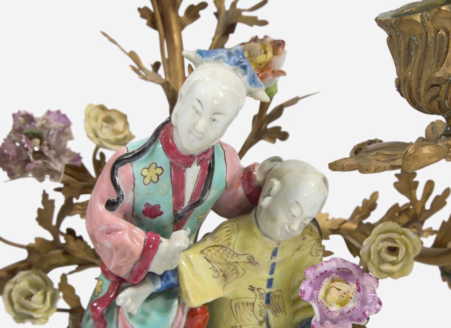 A gilt-bronze mounted Chinese figural porcelain three-light candelabra, the figure 18th century, the gilt bronze 19th century