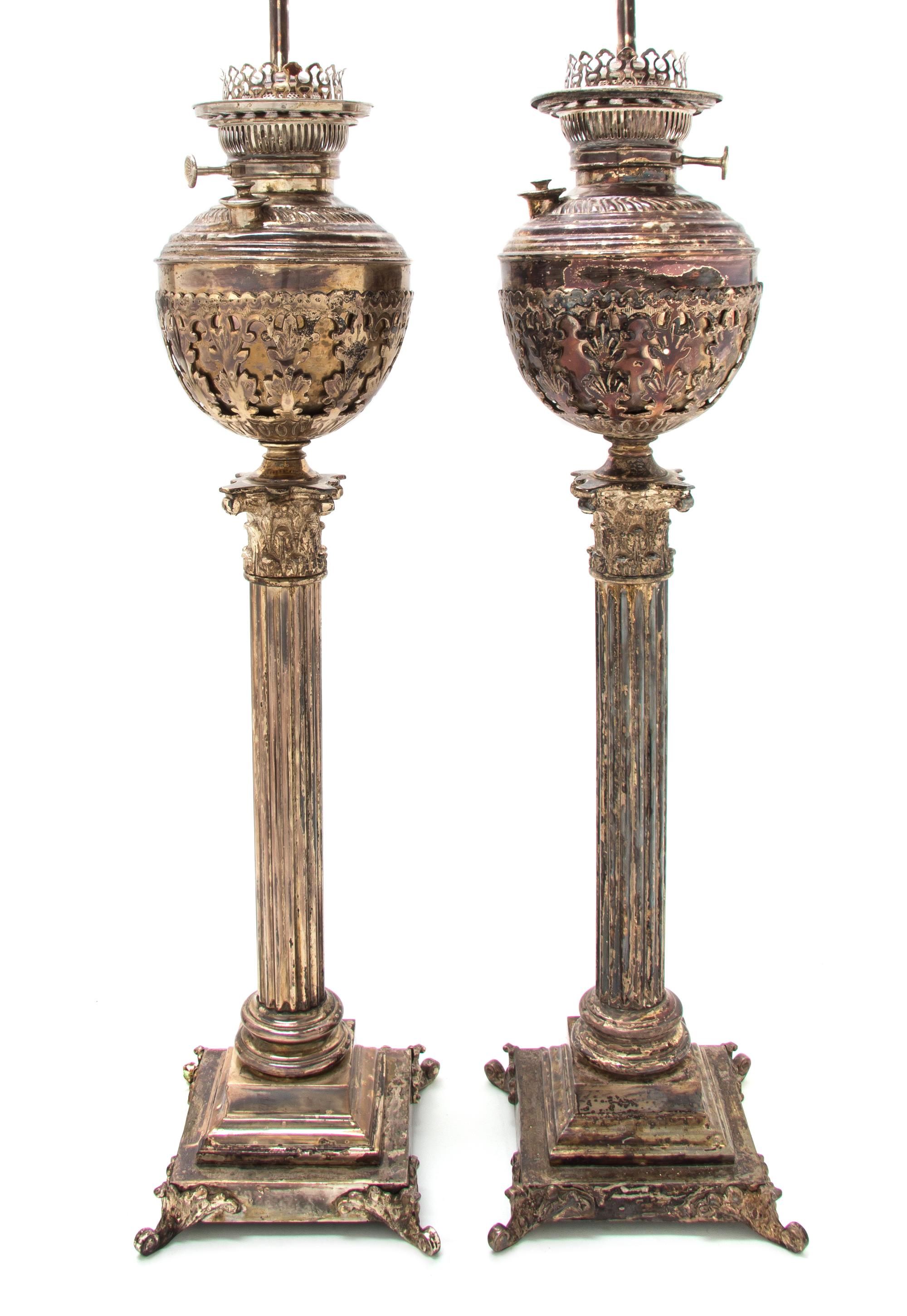 A Pair of Victorian Silver-Plate Oil Lamps, Height 28 1/4 inches.