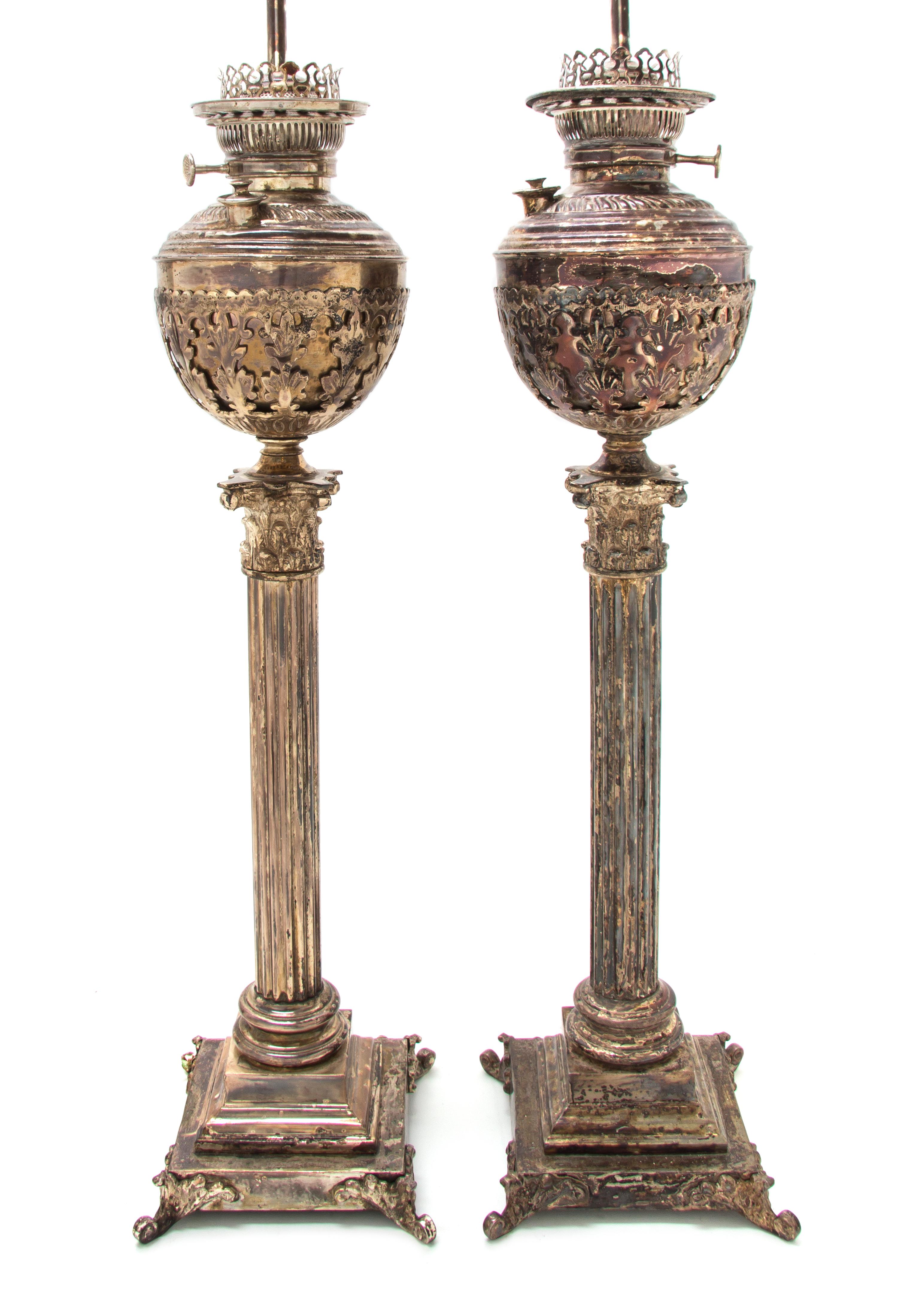 A Pair of Victorian Silver-Plate Oil Lamps, Height 28 1/4 inches.