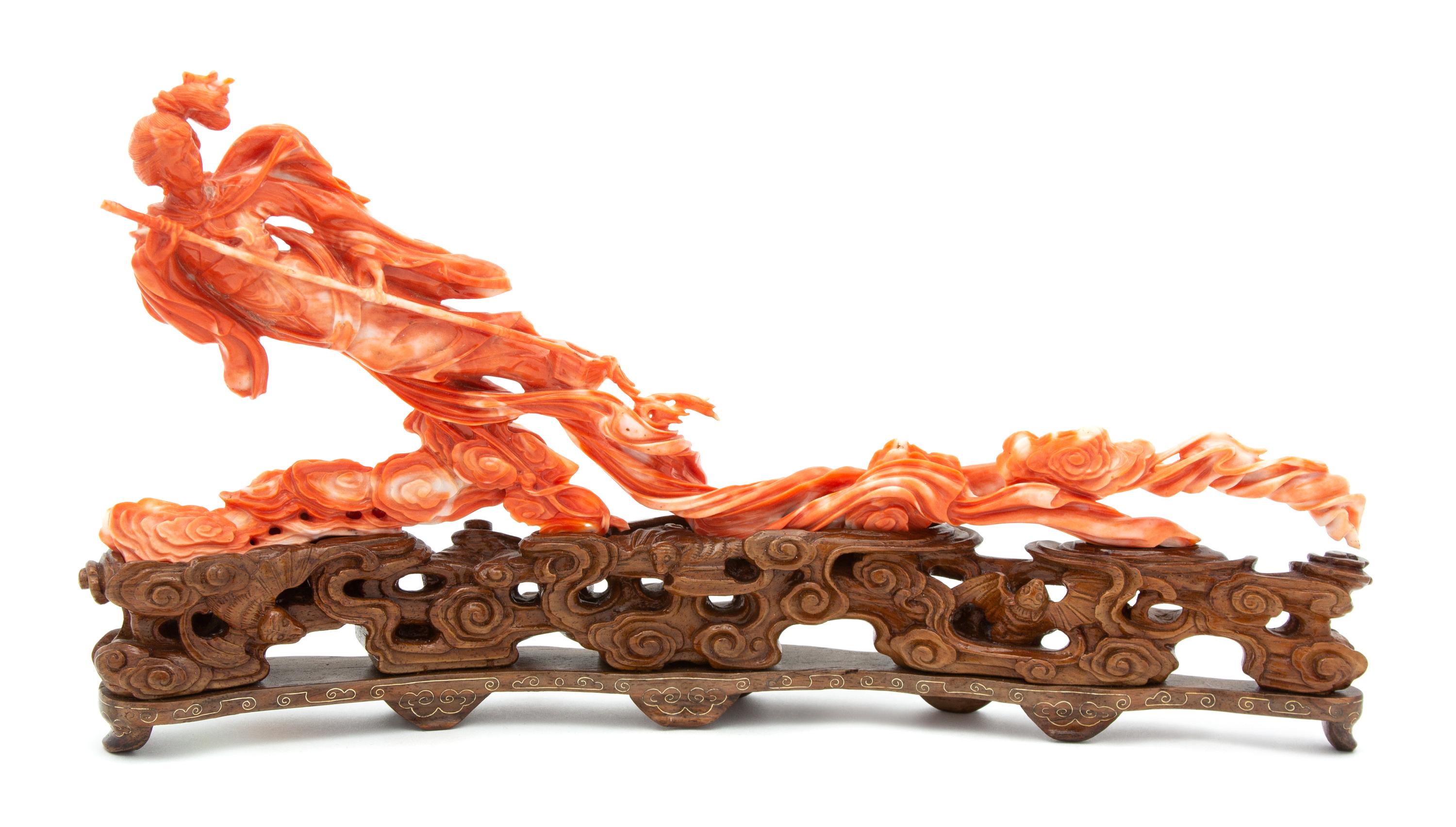 A Chinese Carved Coral Figure of an Immortal Floating on Clouds Height 12 x width 6 1/4 x depth 2 1/2 inches. — 20TH CENTURY