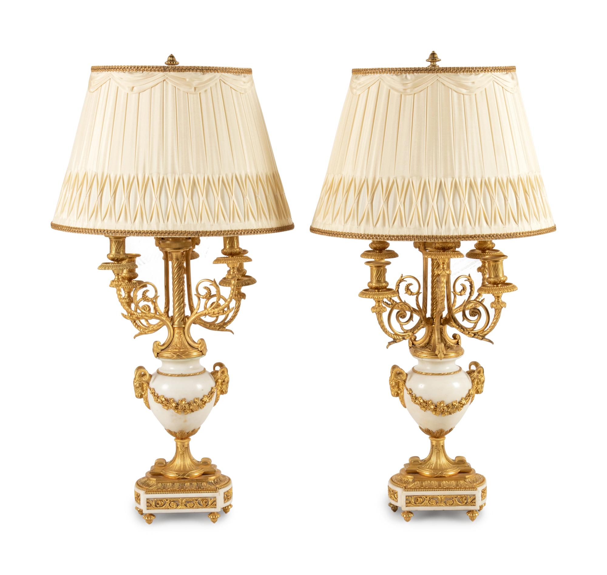 A Pair of Louis XVI Style Gilt Bronze and White Marble Six-Light Candelabra