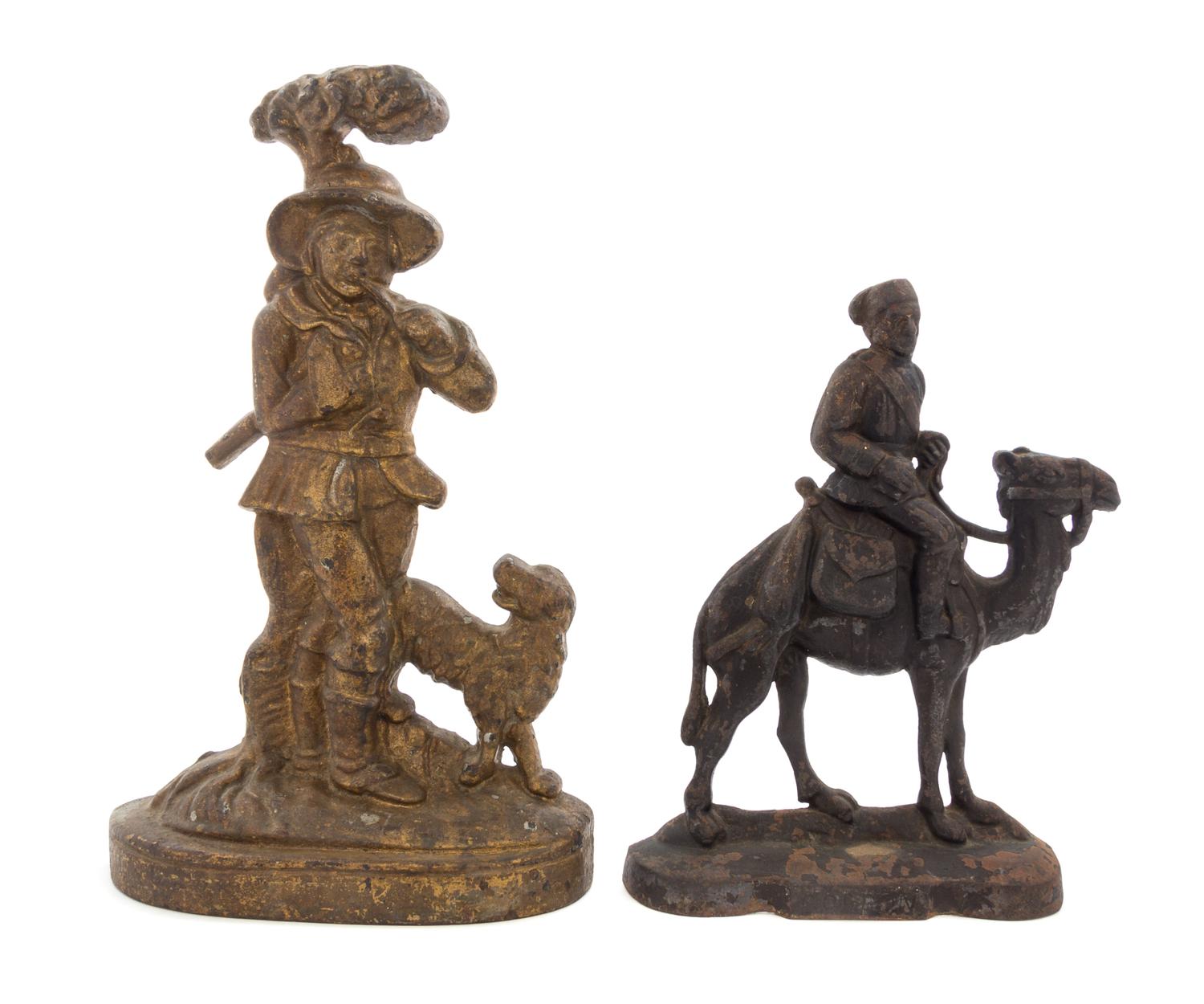 Two Cast Iron Doorstops Height of tallest 14 3/4 inches.