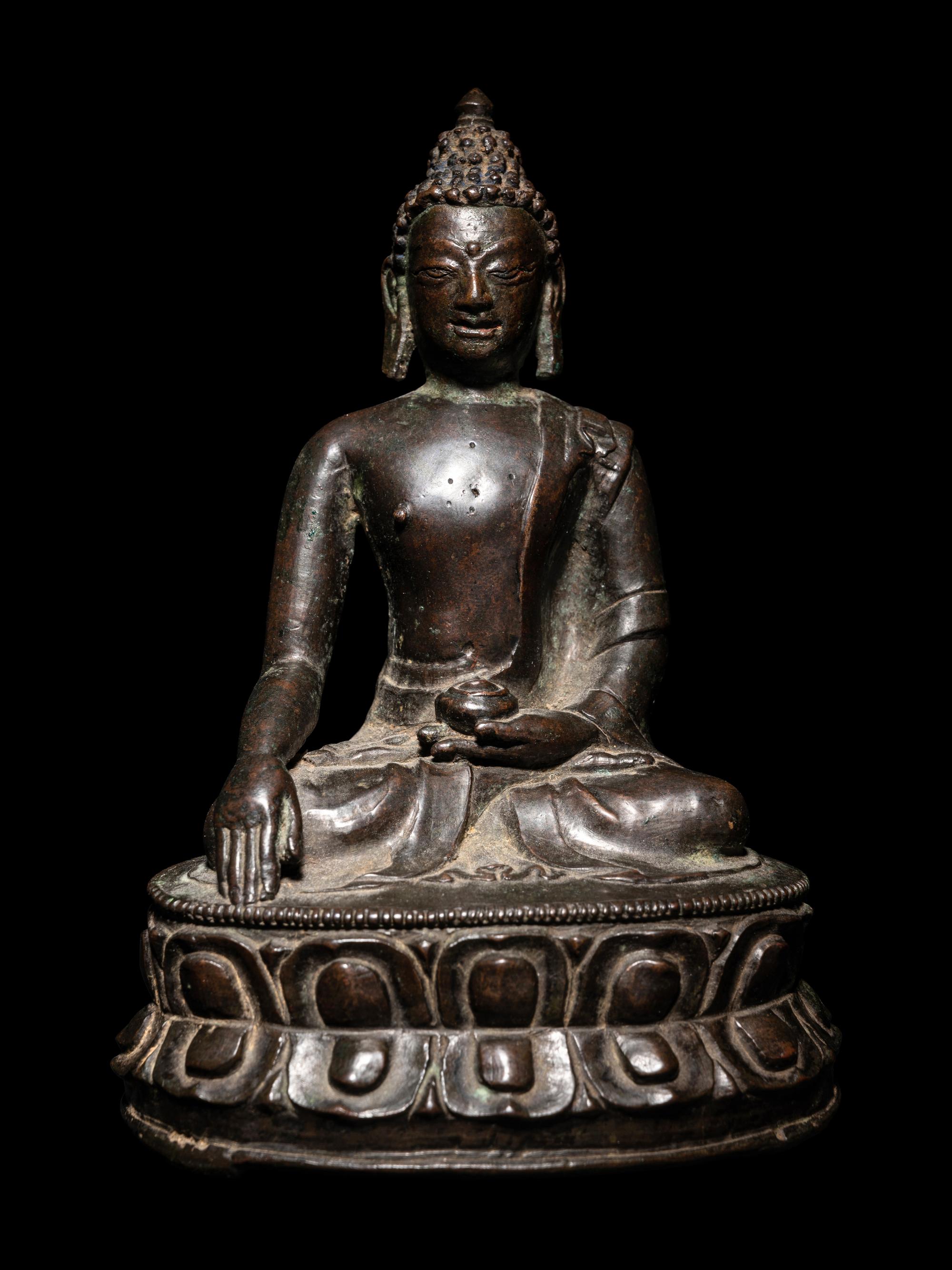 A Tibetan Bronze Figure of Seated Buddha Akshobhya