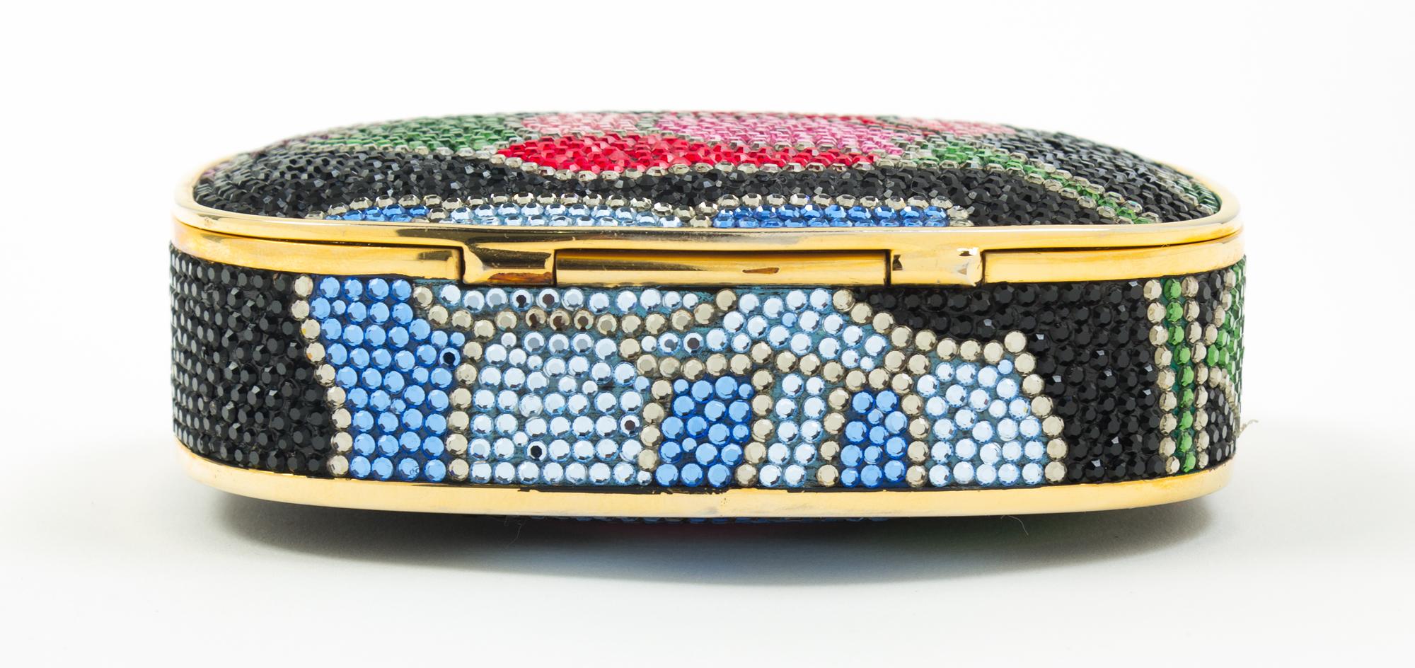A Judith Leiber Black Floral Minaudiere, 3.75"H x 5"W x 1"D; Strap drop: 19.5".