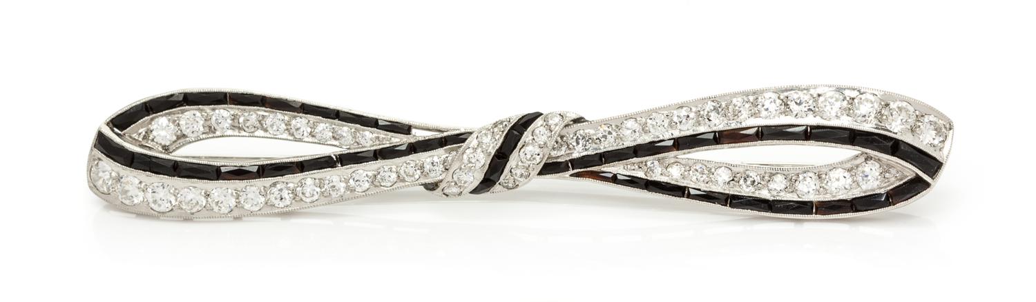 An Art Deco Platinum, Diamond and Onyx Bar Brooch, 5.80 dwts.