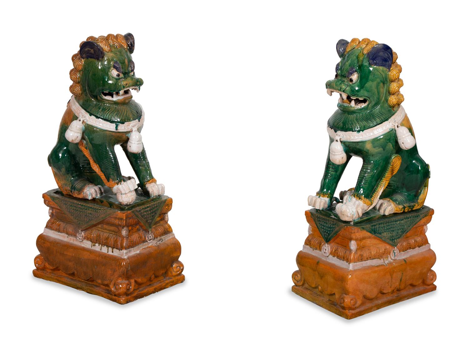 A Pair of Chinese Sançai Glazed Ceramic Guardian Lions on Pedestal Bases