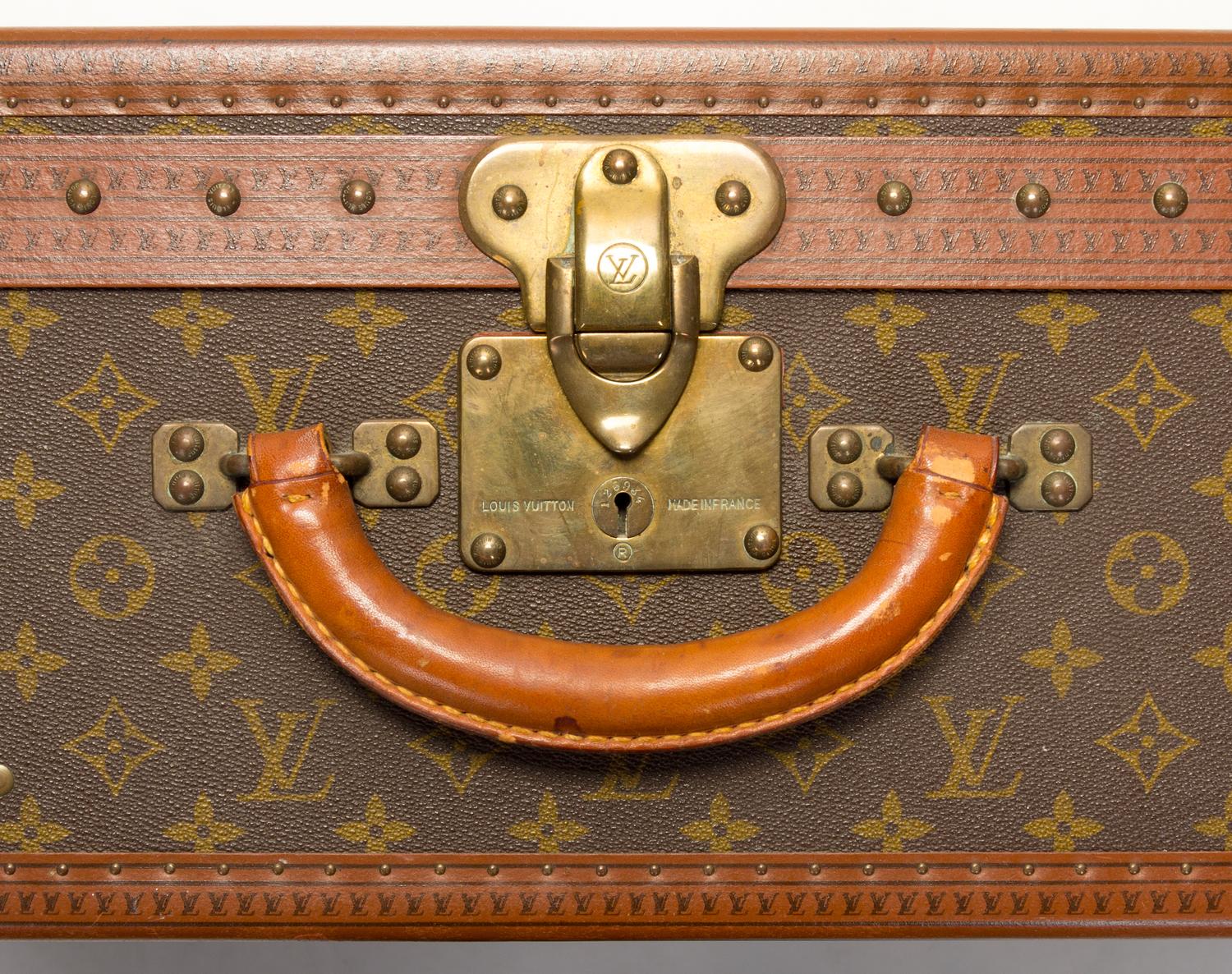 A Louis Vuitton Monogram Canvas Alzer Suitcase, 16" H x 23.5"W x 8.25"D; Handle drop: 2".