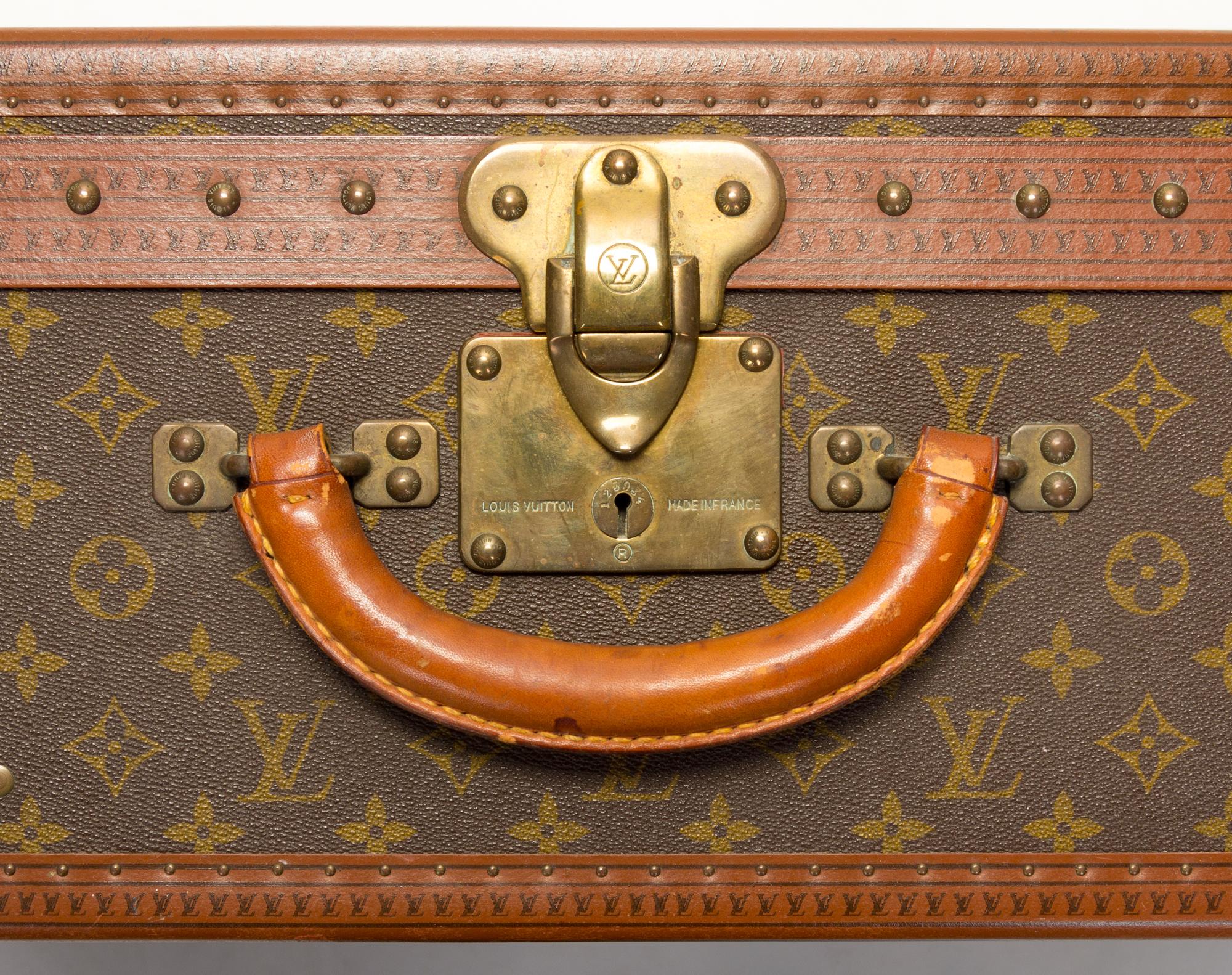 A Louis Vuitton Monogram Canvas Alzer Suitcase, 16" H x 23.5"W x 8.25"D; Handle drop: 2".
