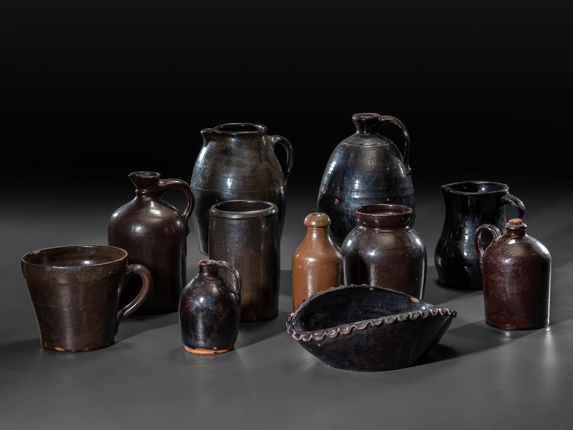 Eleven Albany Slip Stoneware and Redware Vessels