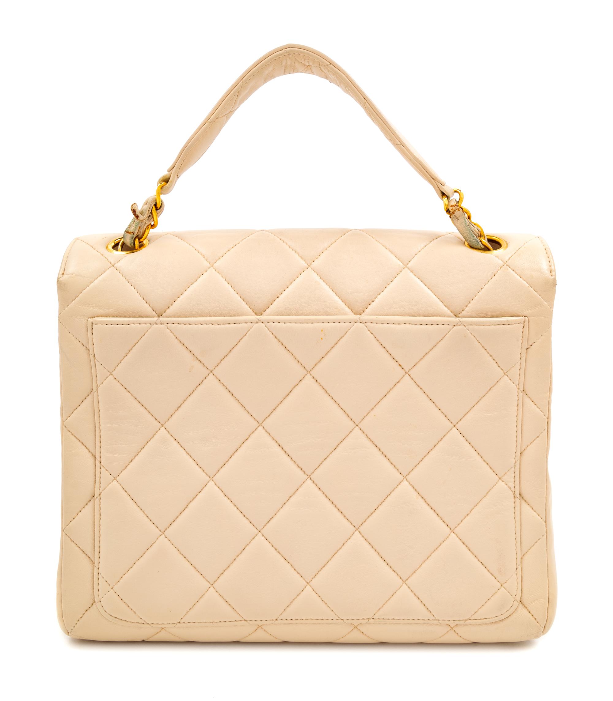 A Chanel Cream Lambskin Quilted Square Flap Bag, 8" H x 9.5" W x 3" D; Handle drop: 3".