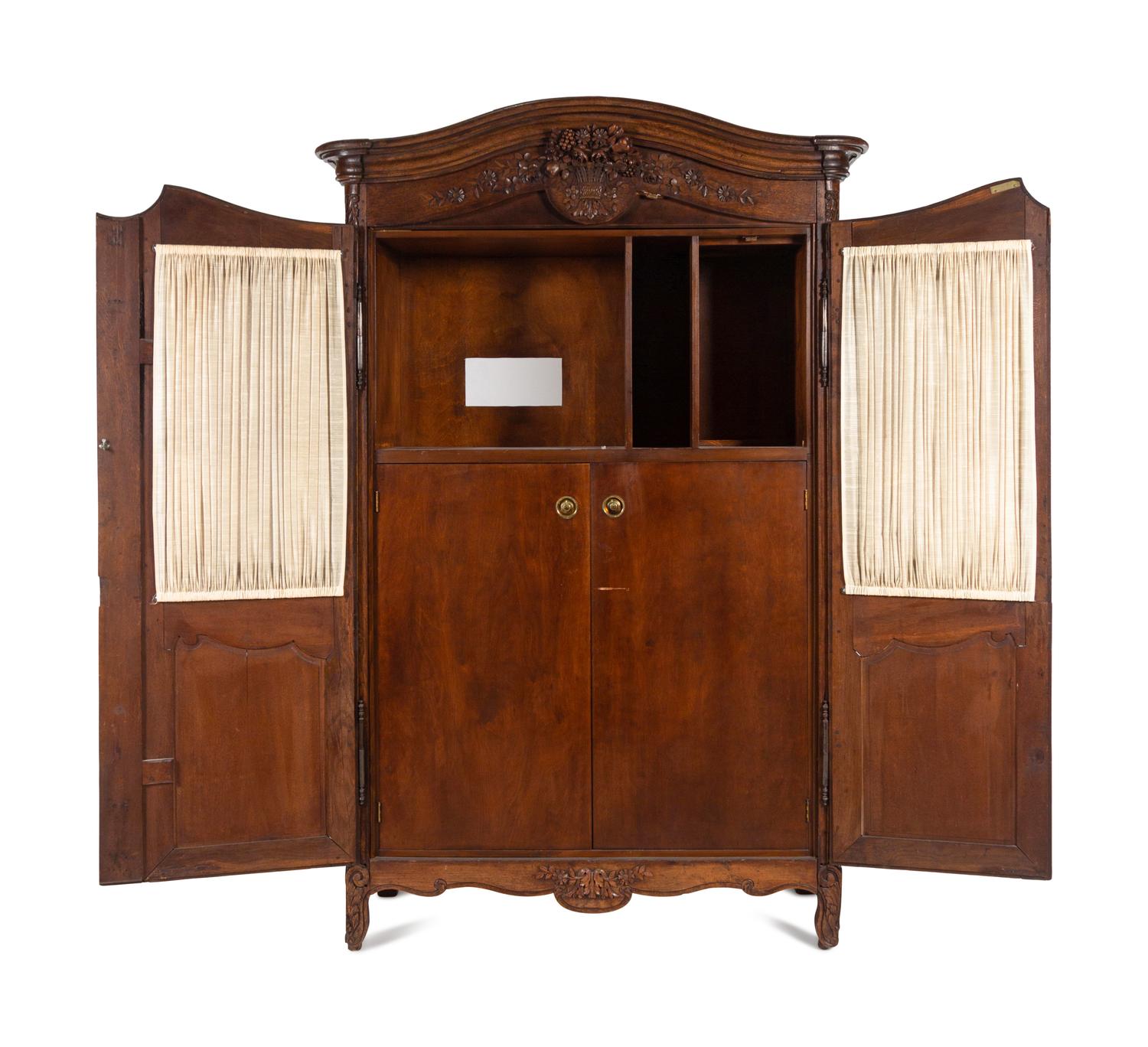 A Louis XV Provincial Style Carved Walnut Armoire