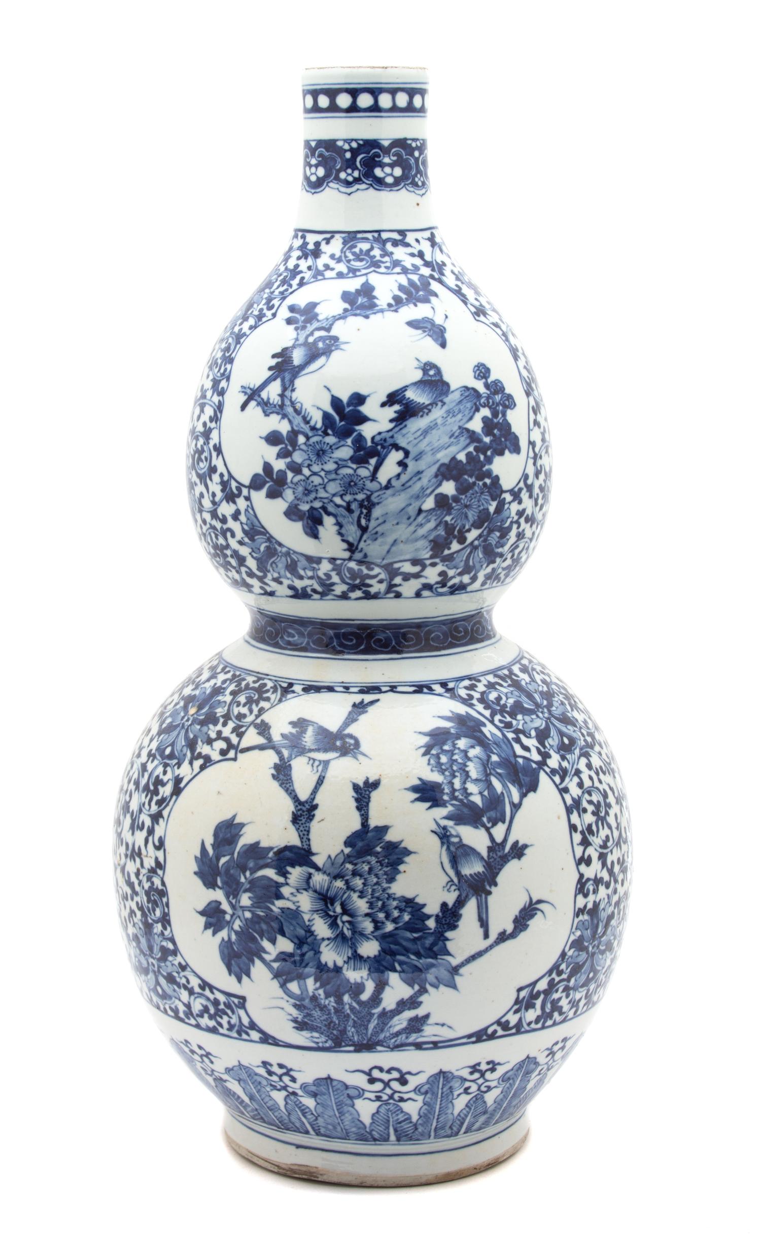 A Chinese Export Blue and White Porcelain Gourd Vase Height 22 1/2 inches. — 19TH CENTURY