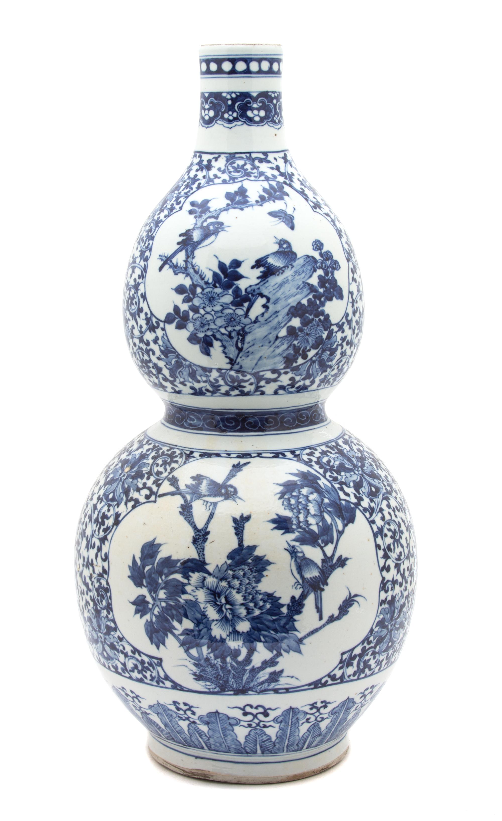 A Chinese Export Blue and White Porcelain Gourd Vase Height 22 1/2 inches. — 19TH CENTURY