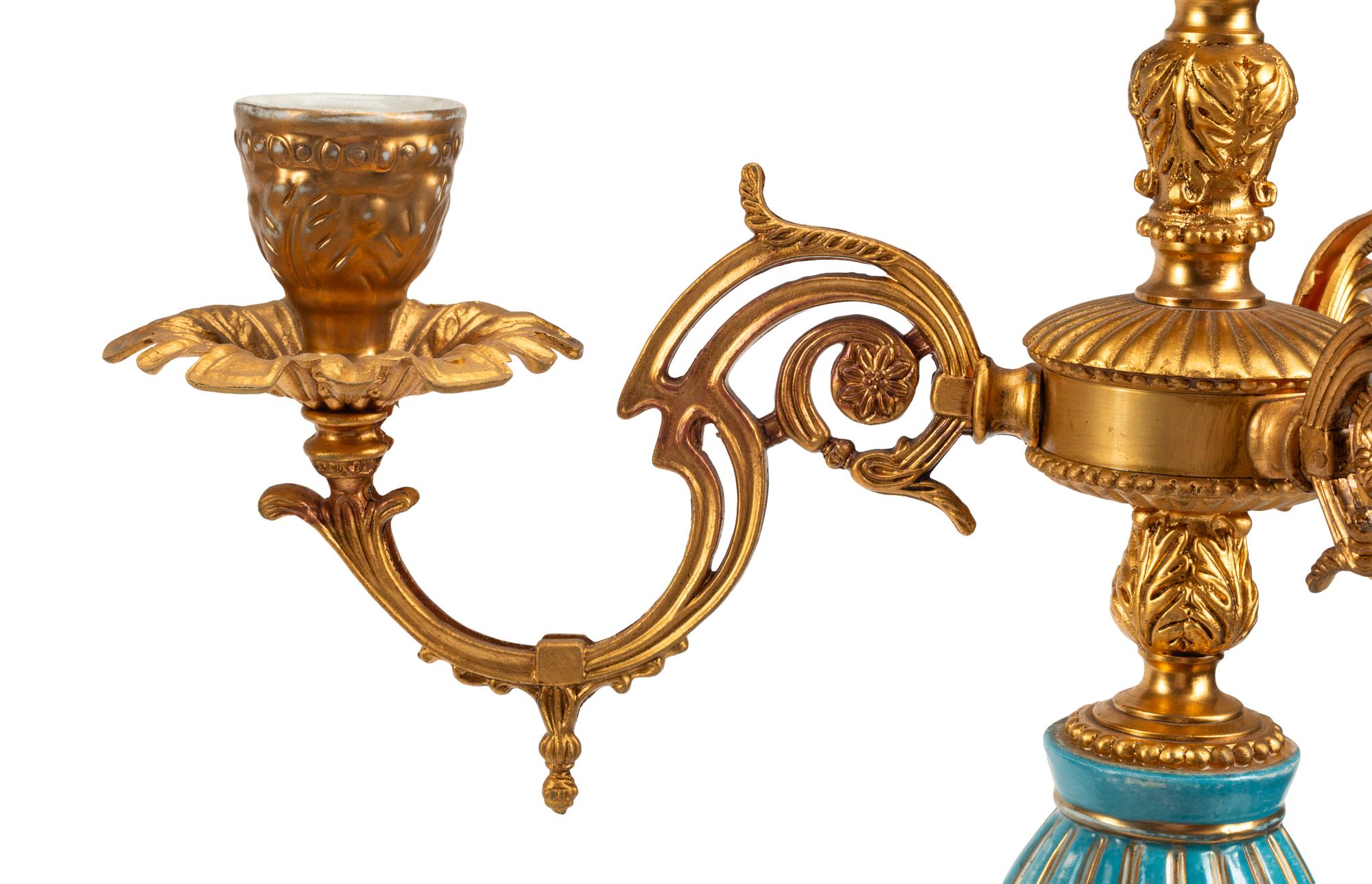 A Pair of Gilt Metal and Porcelain Figural Four-Light Candelabra