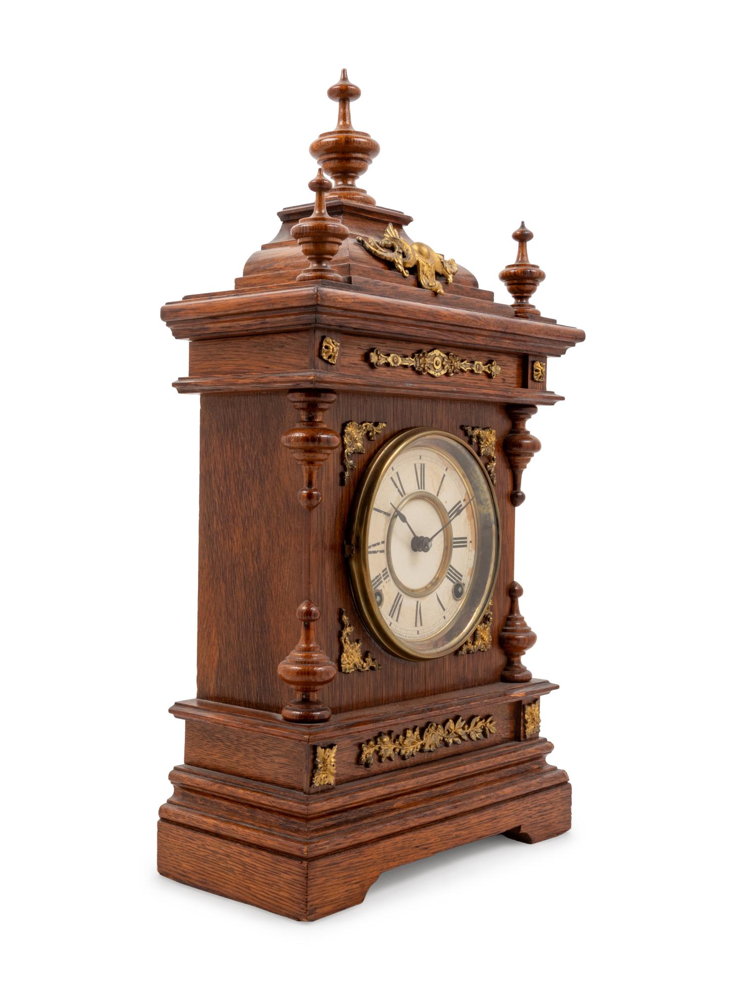 An Ansonia Cabinet A Brass Mounted Oak Shelf Clock