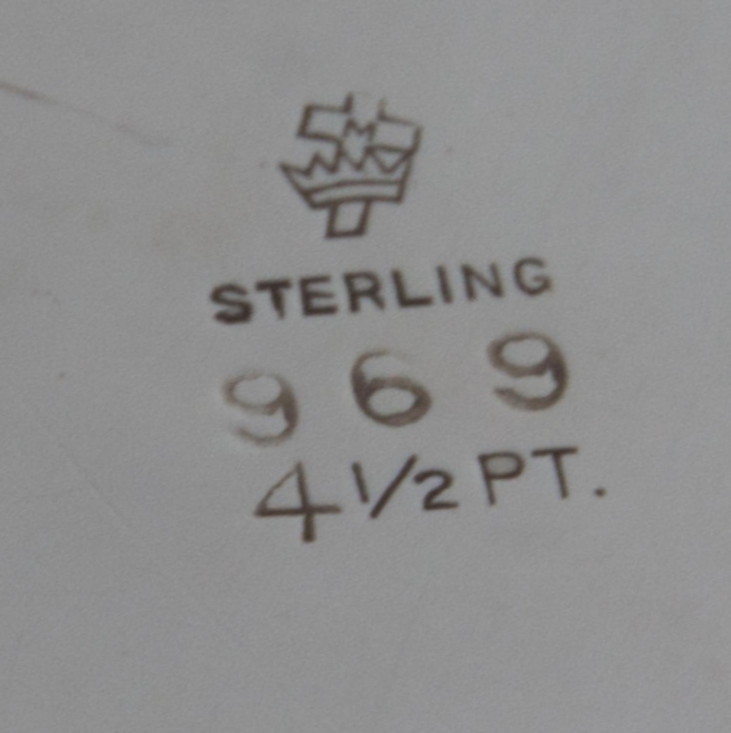 An American Silver Water Pitcher, Manchester Silver Company, Providence, RI, having a baluster form body with a C-scroll handle.