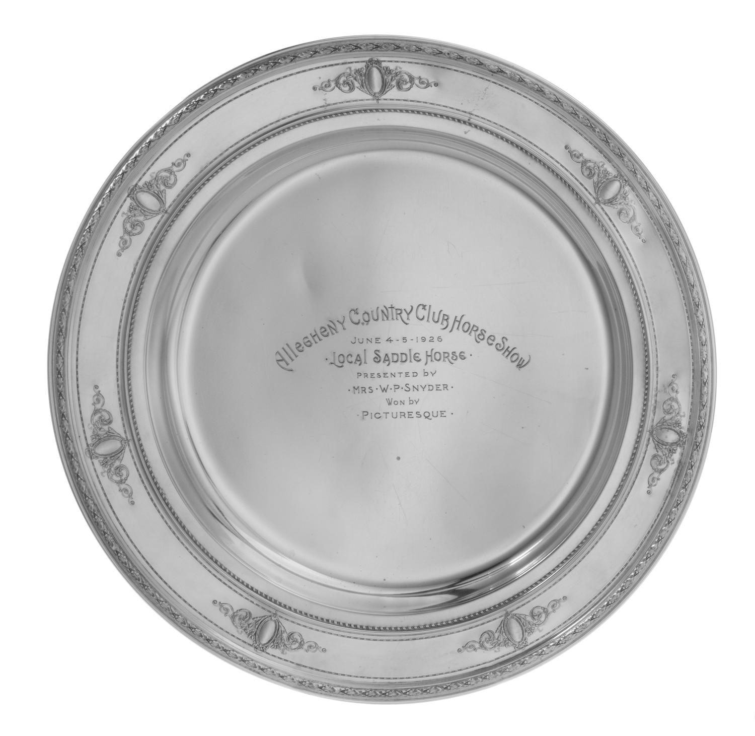 An American Silver Presentation Plate, Reed & Barton, Taunton, MA, having a foliate decorated rim with a ribbon and foliate cartouche d