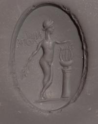 A Roman Copper Alloy and Chalcedony Finger Ring with the God Apollo