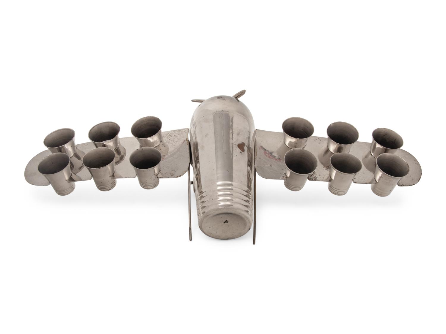 A Silver-Plate Airplane-Form Cocktail Shaker and Shot Glass Set