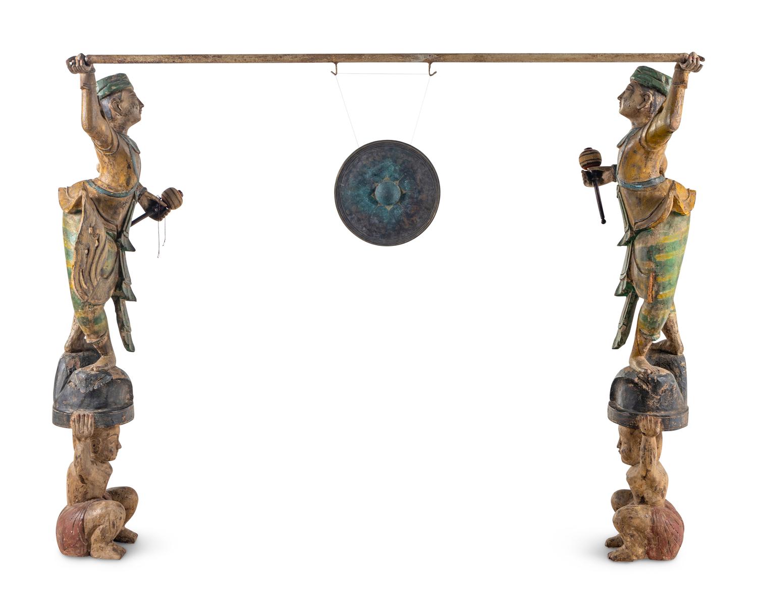 A Pair of Southeast Asian Carved and Polychrome Decorated Figures with a Gong