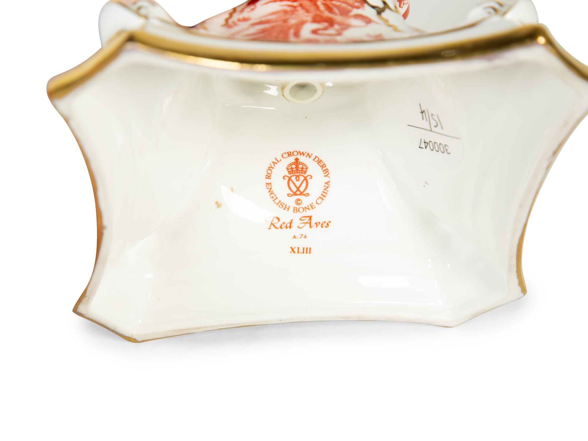 A Royal Crown Derby Red Aves Covered Tureen with Under Plate and a Pair of Candlesticks