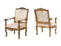 A Pair of Régence Style Carved Giltwood Fauteuils