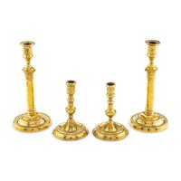 A Collection of Two Pairs of Brass Candlesticks