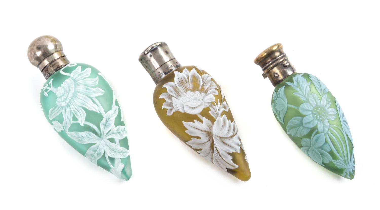 English, LATE 19TH CENTURY, three silver mounted cameo glass perfume bottles, each of tapering form with floral decoration