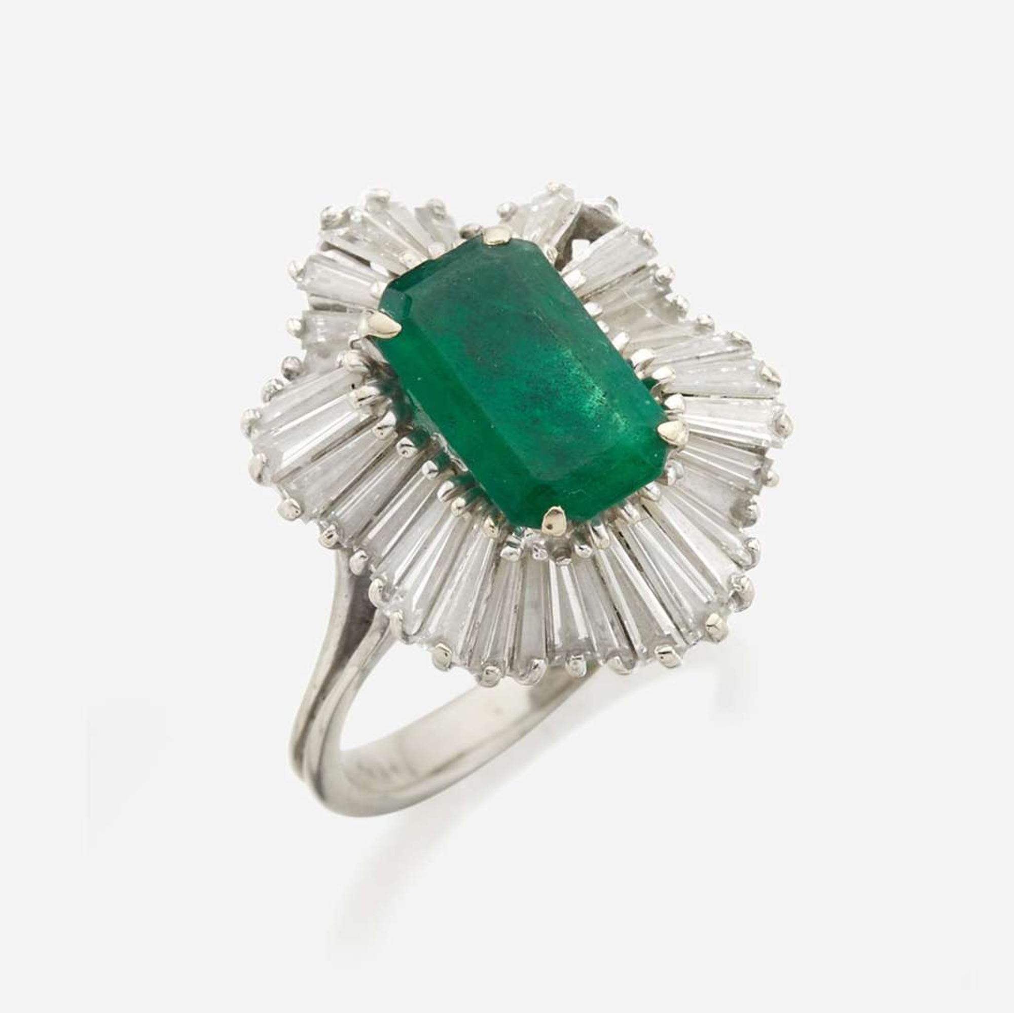 An emerald, diamond, and white gold ring
