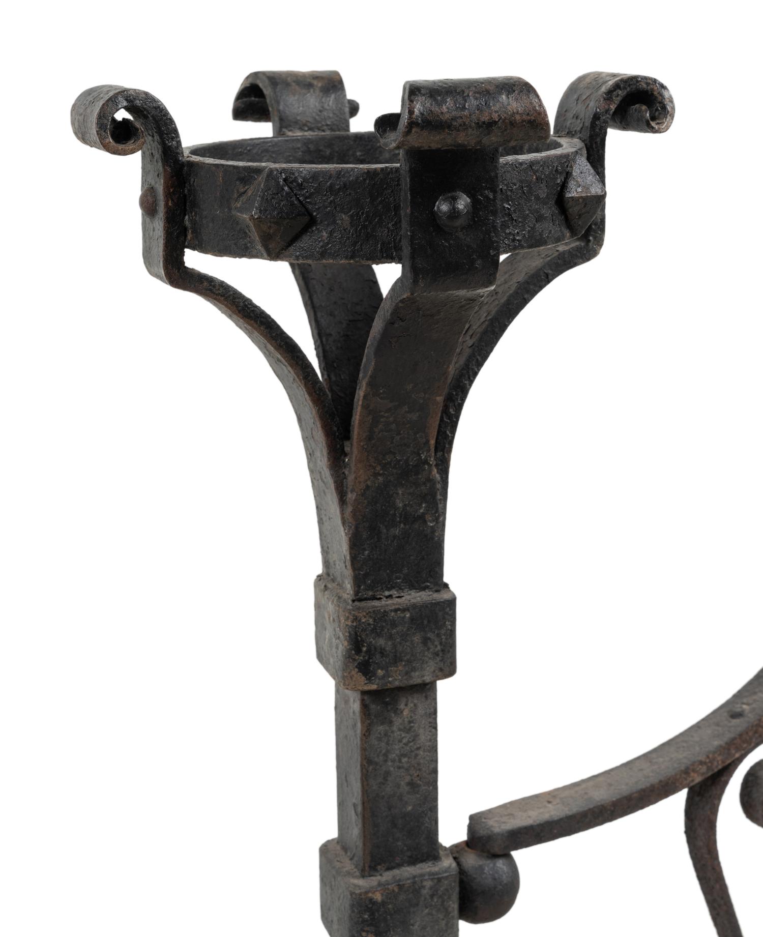 A Pair of Continental Iron Andirons with Posset Cup Holders
