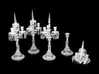 A Set of Four Baccarat Dauphin Three-Light Candelabra