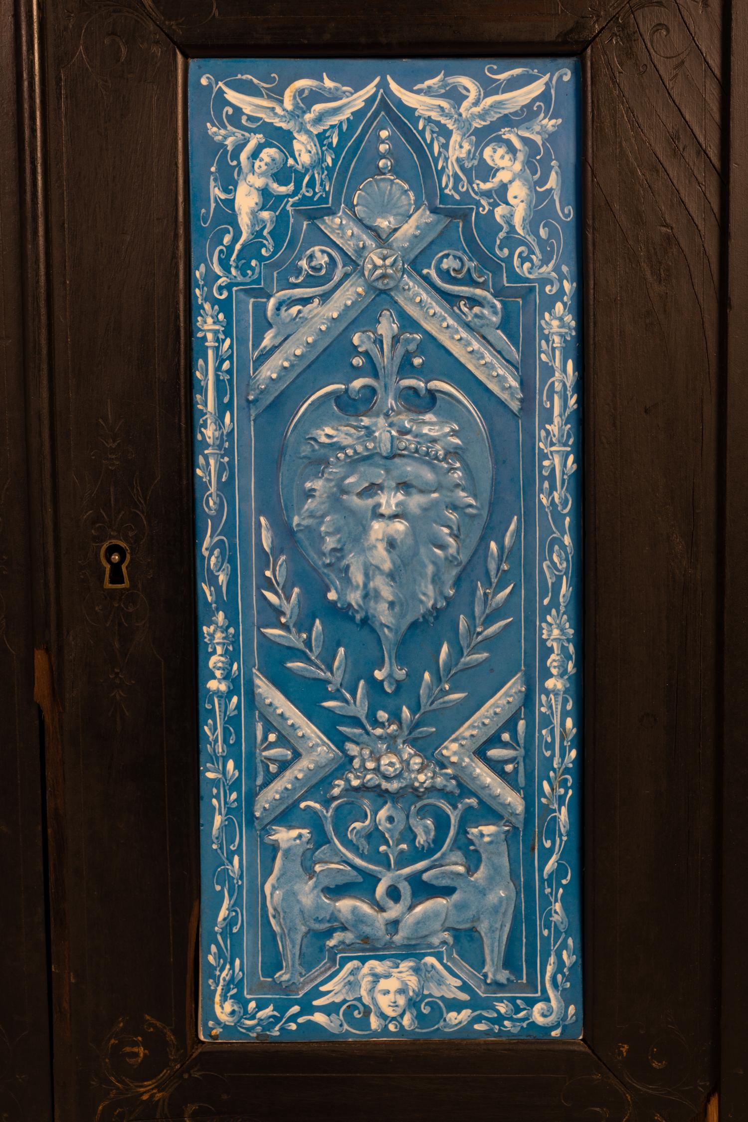 A Continental Blue Faience-Mounted Ebonized Cabinet