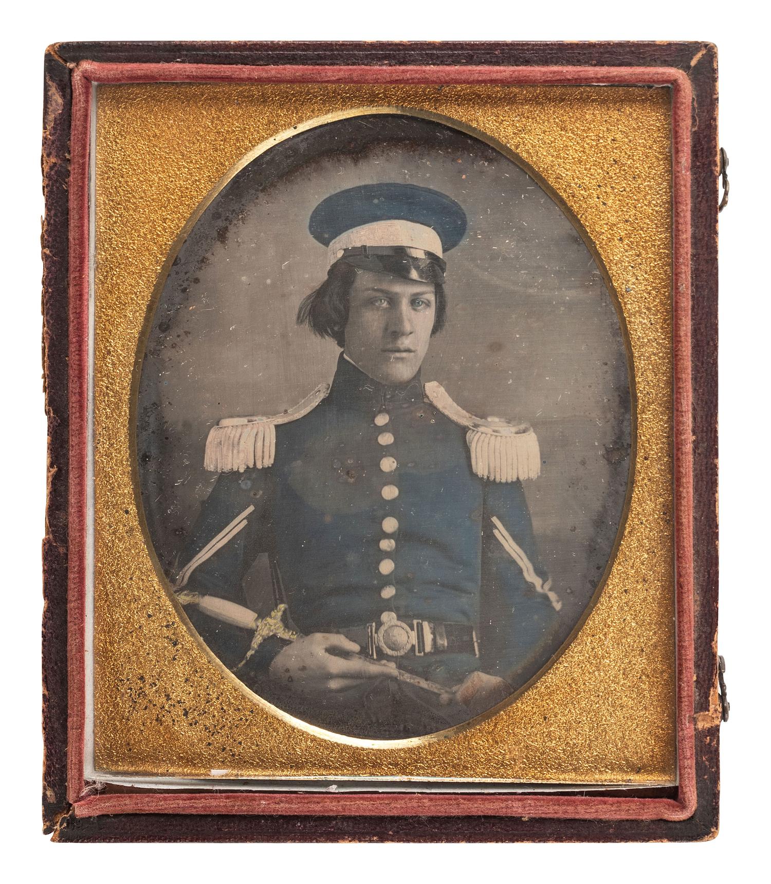 [MEXICAN WAR]. Quarter plate hand-tinted daguerreotype of a militiaman wearing a wheel cap and holding a militia officer's sword.