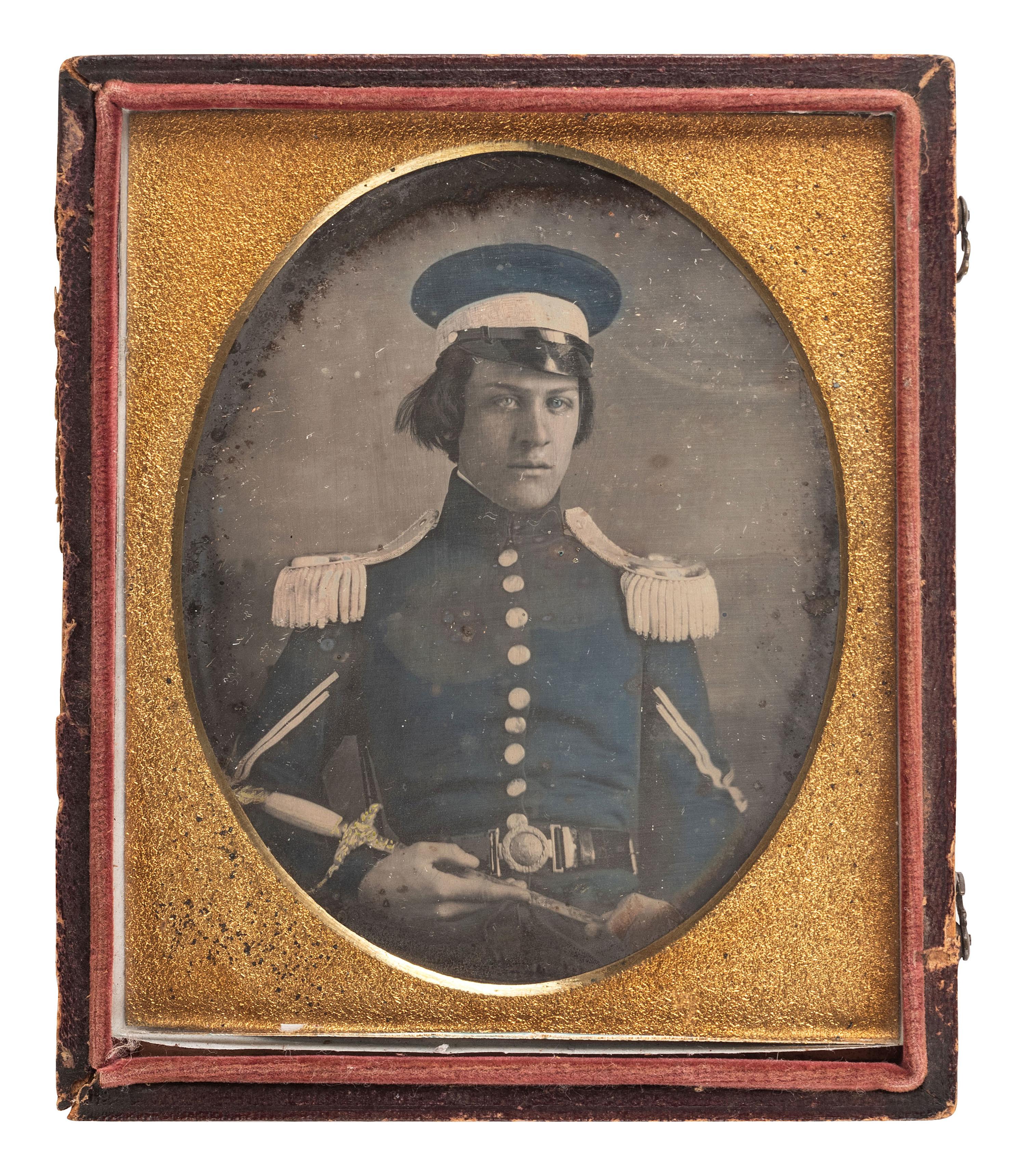 [MEXICAN WAR]. Quarter plate hand-tinted daguerreotype of a militiaman wearing a wheel cap and holding a militia officer's sword.