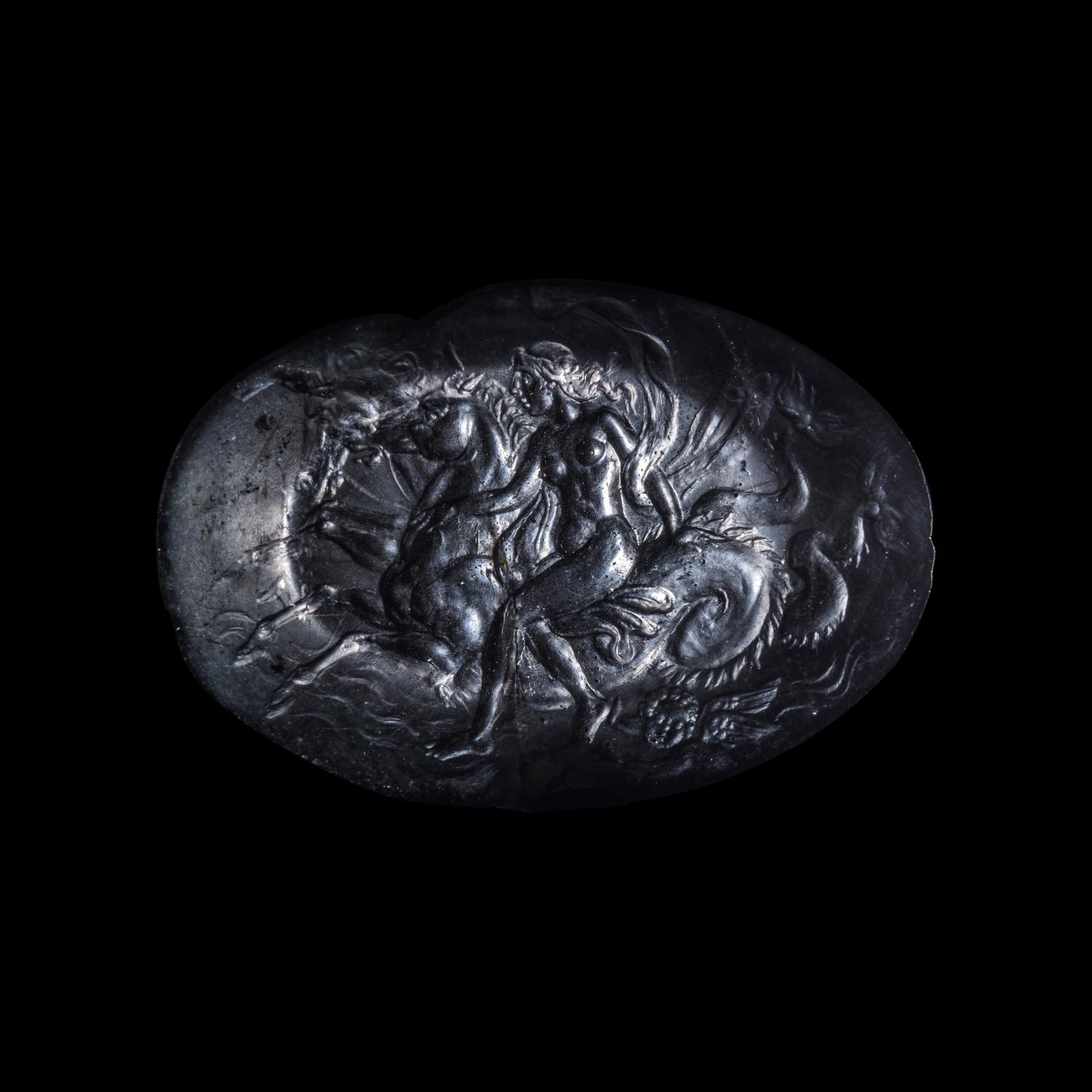 A Roman Smokey Quartz Intaglio with a Nereid Riding Two Hippocamps