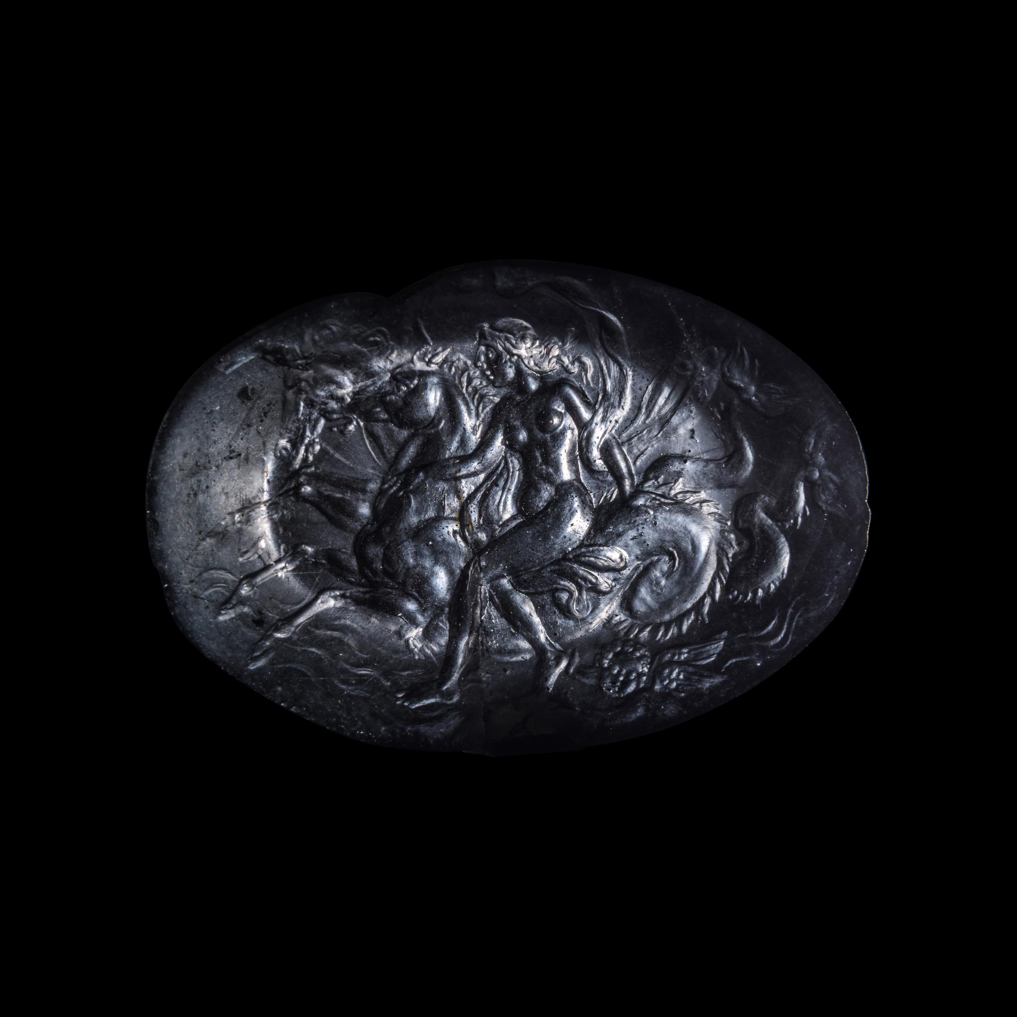 A Roman Smokey Quartz Intaglio with a Nereid Riding Two Hippocamps