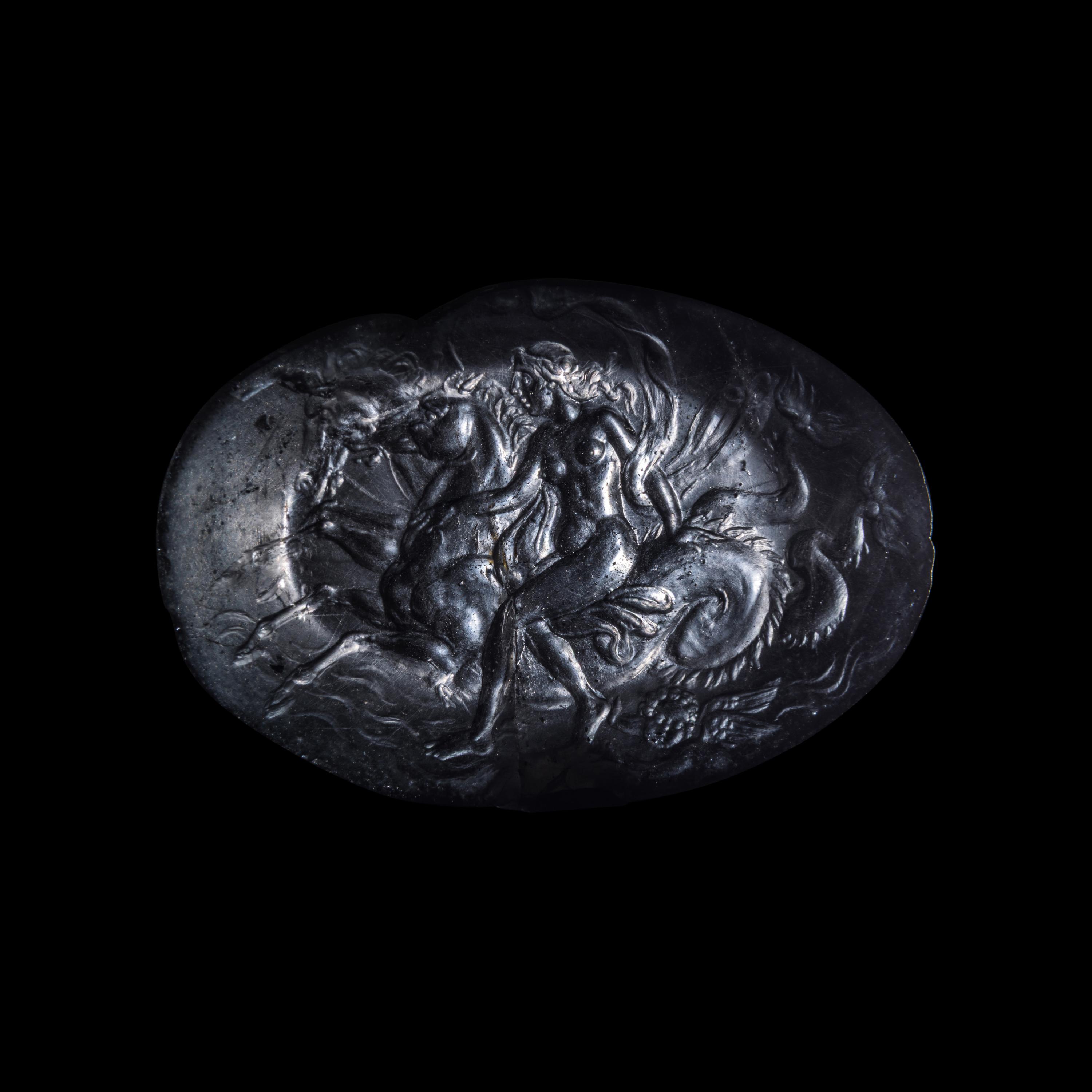 A Roman Smokey Quartz Intaglio with a Nereid Riding Two Hippocamps