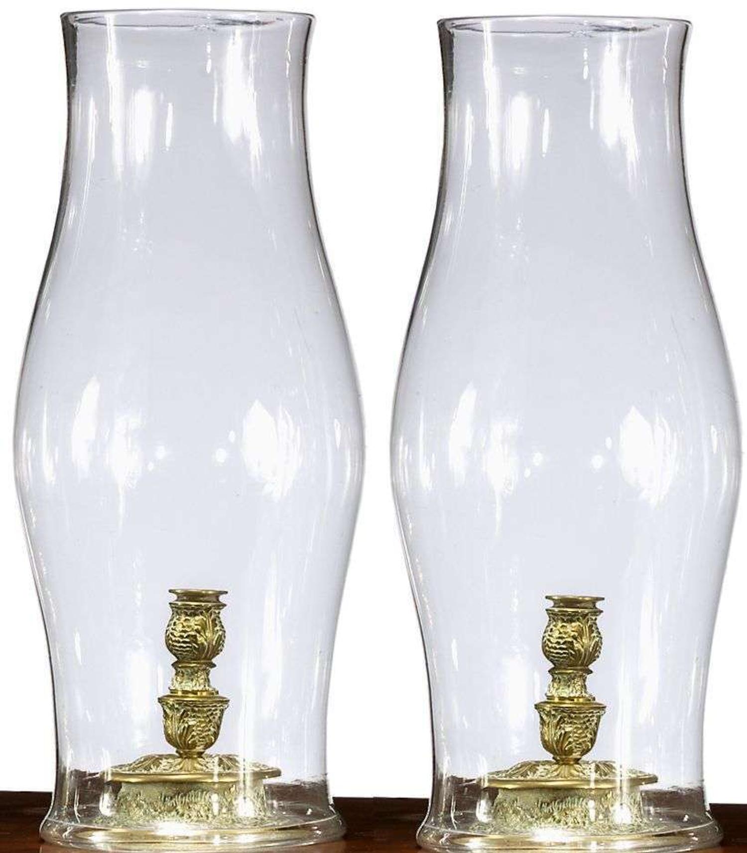 Pair of Continental brass candlesticks with blown glass hurricane shades 18th/19th century