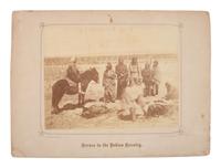 GARDNER, Alexander (1821-1882), photographer. Albumen photograph of members of the Dakota Tribe at the Fort Laramie Council butchering a cow. 1868.