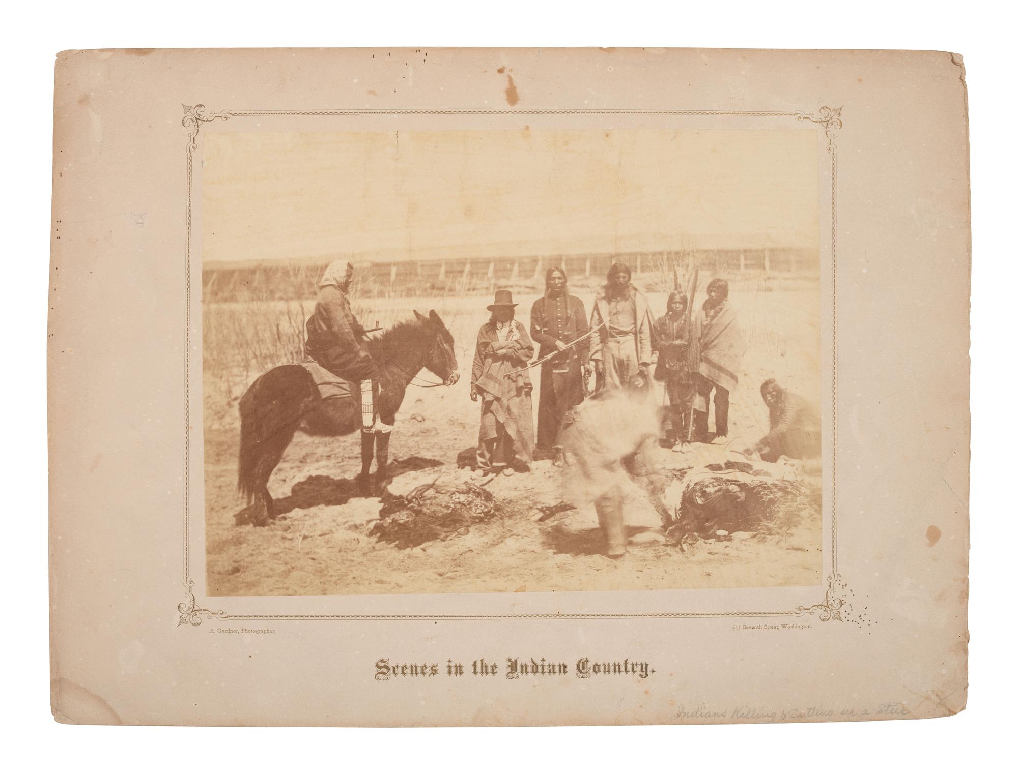 GARDNER, Alexander (1821-1882), photographer. Albumen photograph of members of the Dakota Tribe at the Fort Laramie Council butchering a cow. 1868.