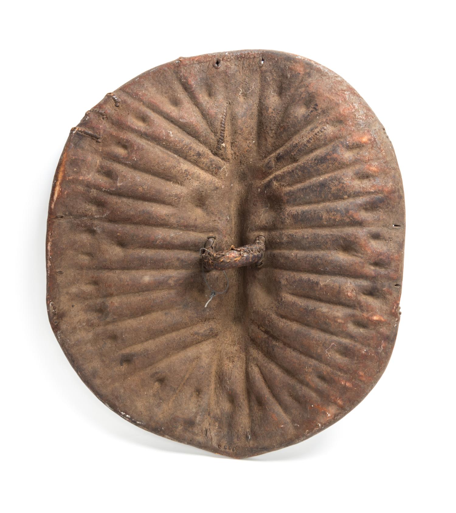 An African Tortoise-Form Leather War Shield, Central Congo. Length 28 3/4 inches.