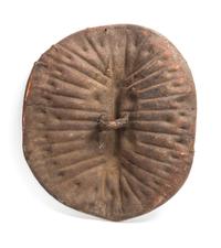 An African Tortoise-Form Leather War Shield, Central Congo. Length 28 3/4 inches.