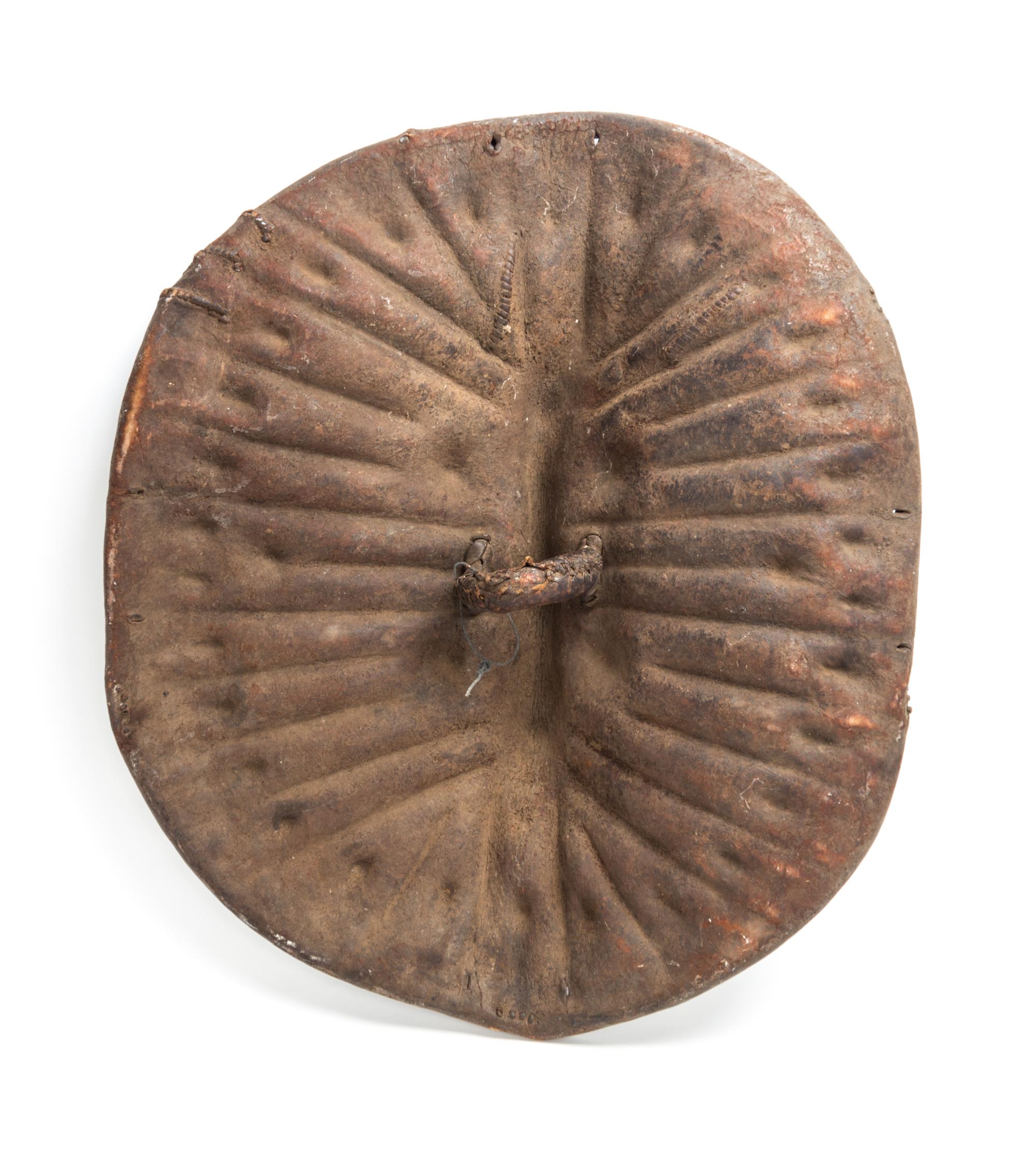An African Tortoise-Form Leather War Shield, Central Congo. Length 28 3/4 inches.