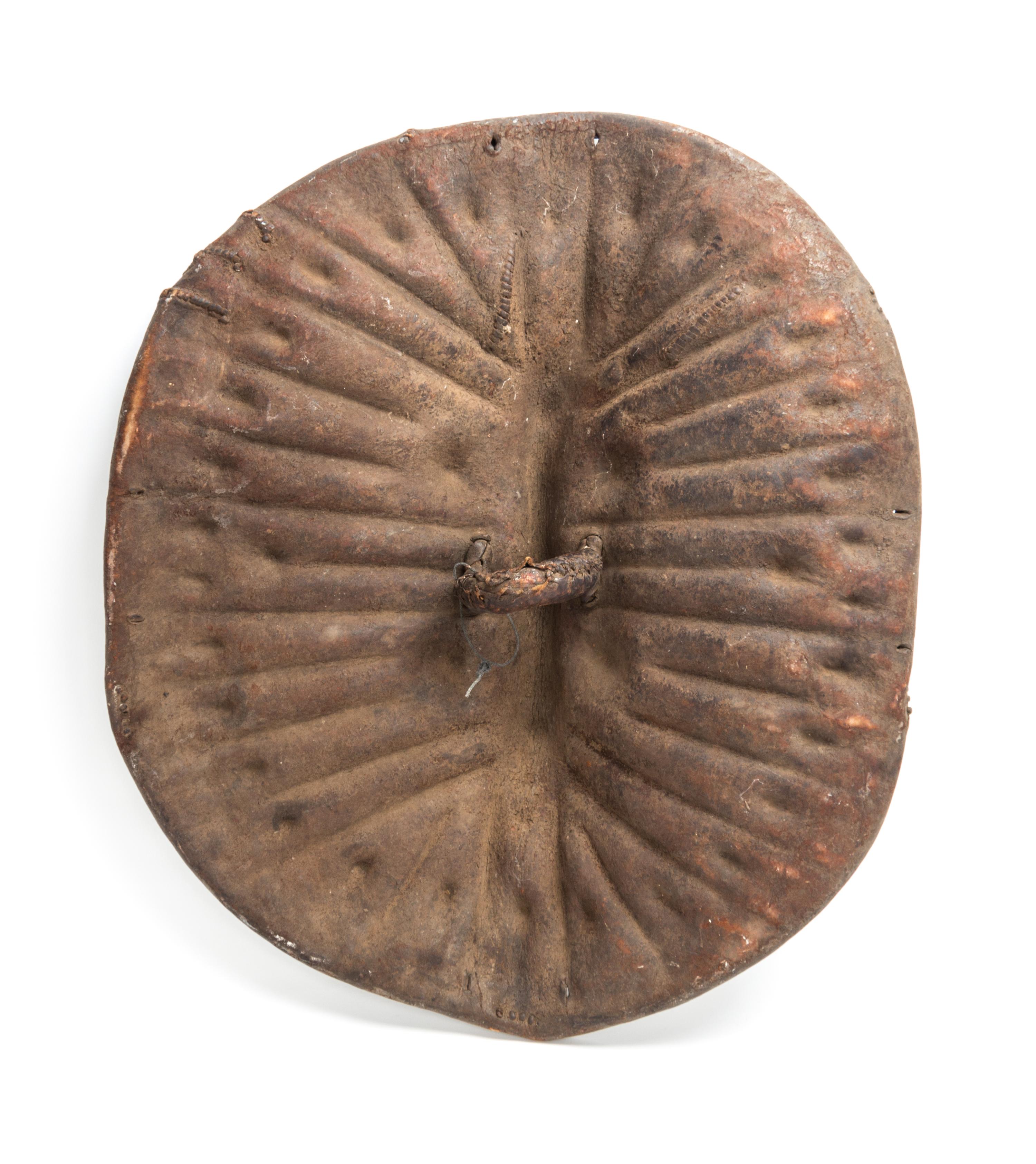 An African Tortoise-Form Leather War Shield, Central Congo. Length 28 3/4 inches.