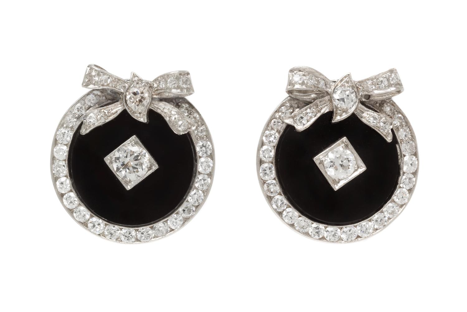 A Pair of Platinum, Diamond and Onyx Earclips, 8.70 dwts.